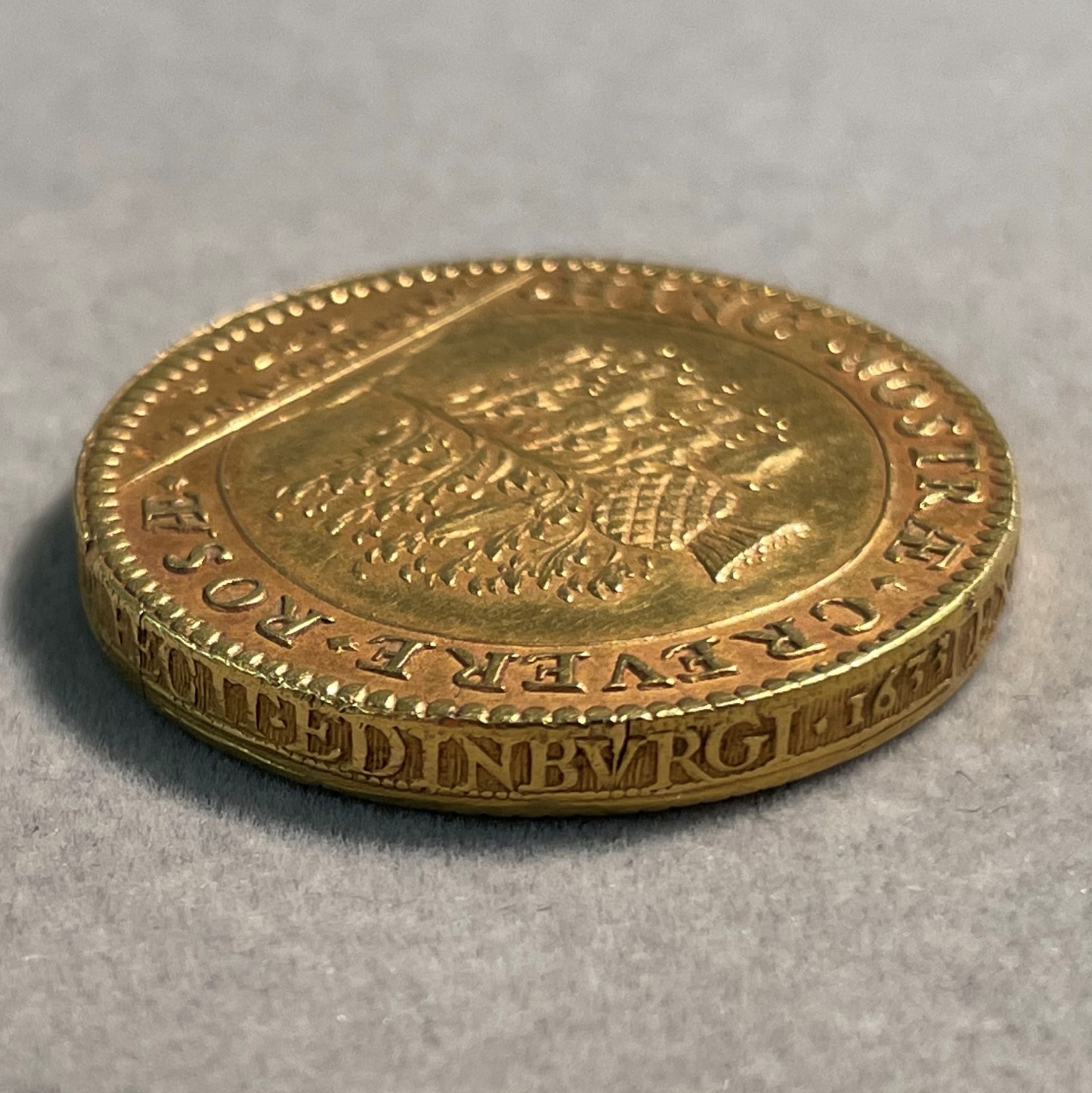 A close up image of a gold coin.